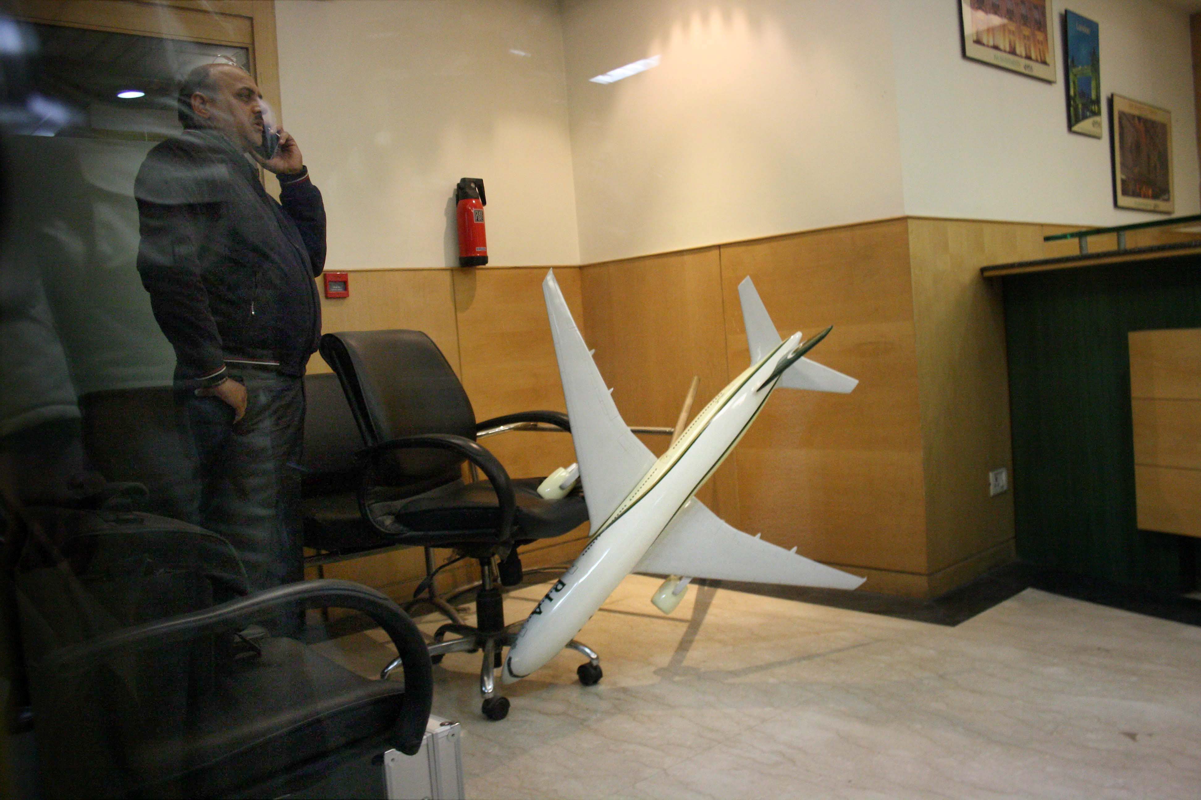 A policeman guards inside the Pakistan International Airlines office after Hindu Sena activists reportedly vandalised it in New Delhi on Thursday. Credit: PTI