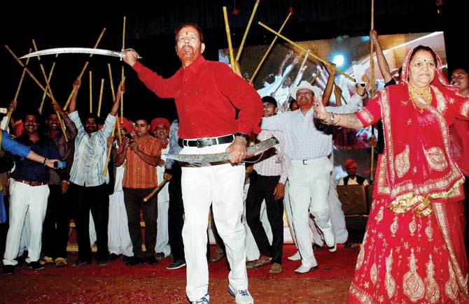 Former IPS officer D.G. Vanzara dances with a sword during a welcome ceremony by his family and community in Gandhinagar on April 8. Credit: PTI