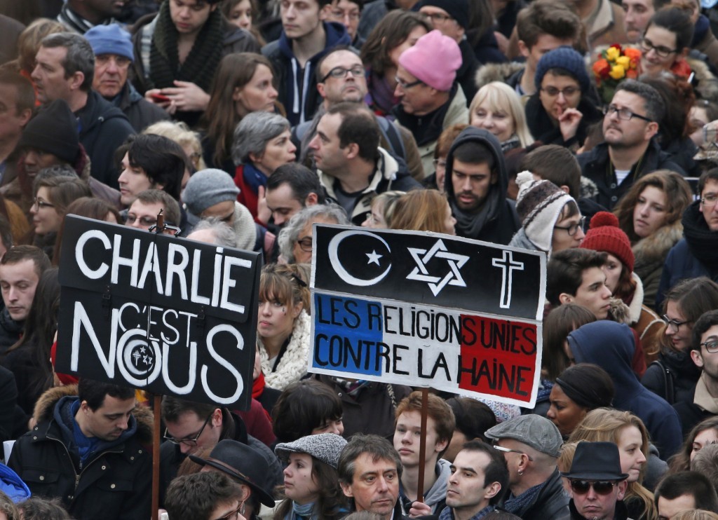 Citizens carrying placards reading “Charlie it is us” and “The religions united against the hatred” take part in a French citizens solidarity march in Paris, January 11, 2015. Credit: Reuters