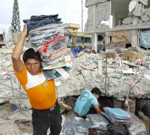 People carry clothing as rescue efforts continue on to a fourth day in Pedernales, after an earthquake struck off Ecuador's Pacific coast. Credit: Reuters