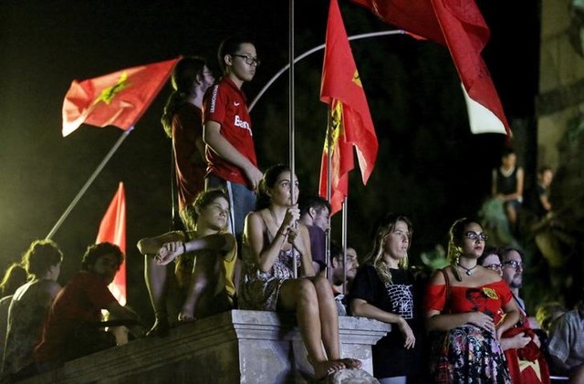 Supporters of President Dilma Rousseff watch in a public park the live transmission of the debate in the Lower House of Congress over the impeachment of President Dilma Rousseff. Credit: Reuters