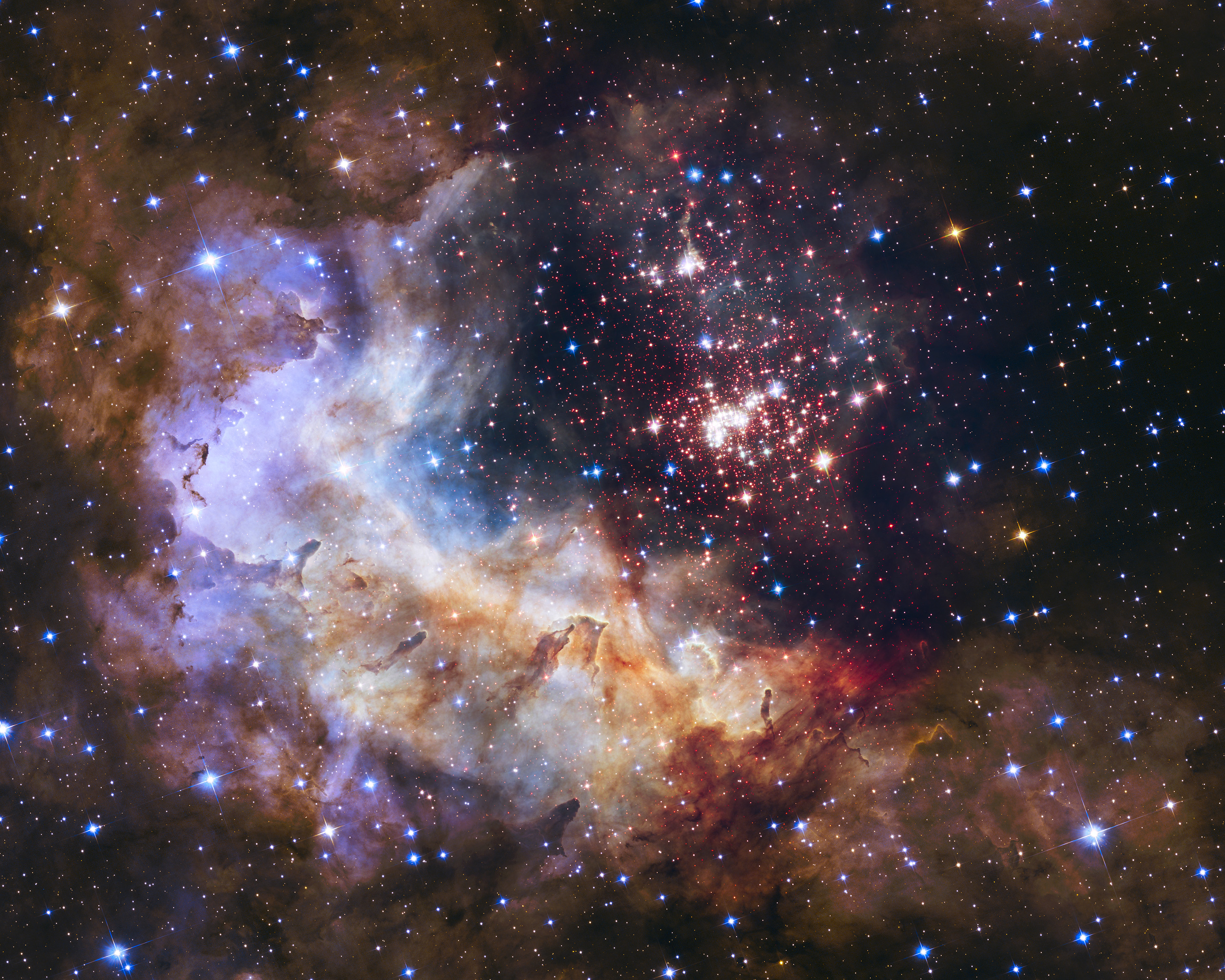 Hubble's 25th anniversary image features a giant, sparkling cluster of about 3,000 stars called Westerlund 2. The cluster resides in a raucous stellar breeding ground known as Gum 29, located 20,000 light-years away from Earth in the constellation Carina. Caption and credit: NASA/ESA