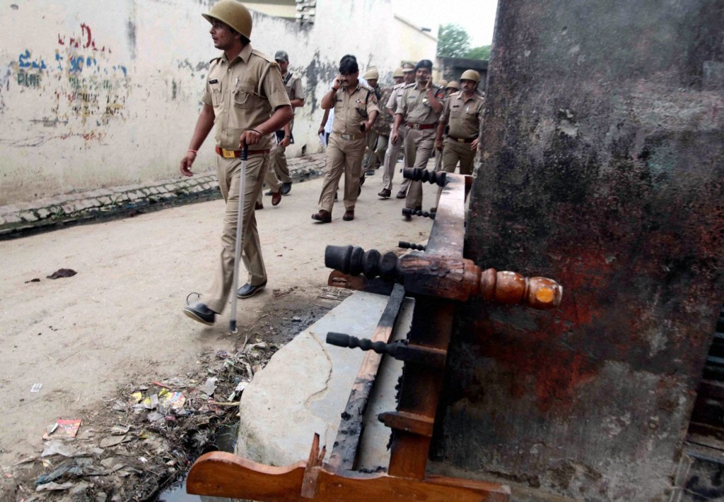 File photo of policemen patrol a street during curfew in Muzaffarnagar Credit: PTI photo by Atul Yadav.