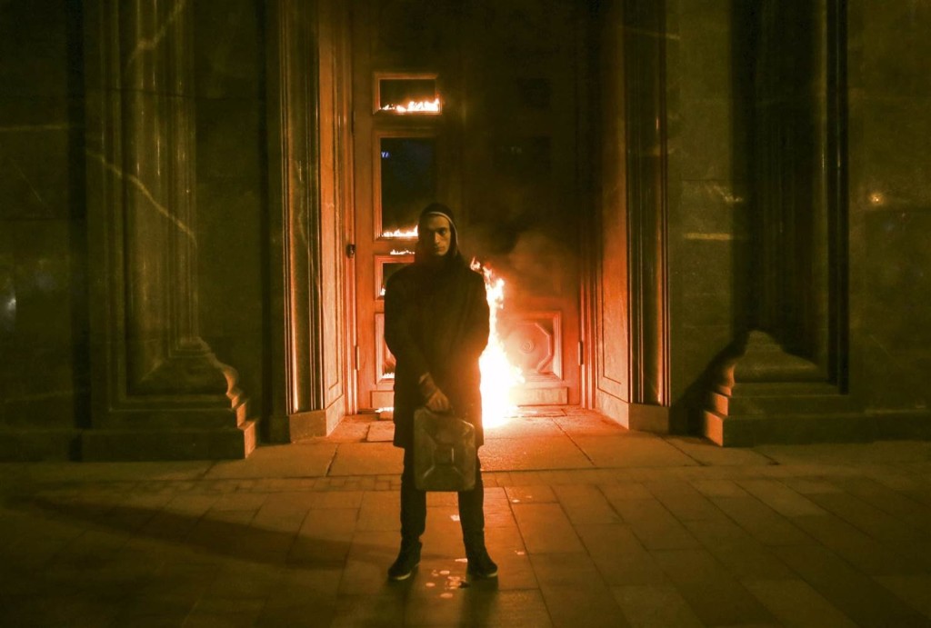 Pyotr Pavlensky in front of the Russian Security Service, whose door he set on fire in November 2015, and for which he now faces imprisonment. Credit: Youtube