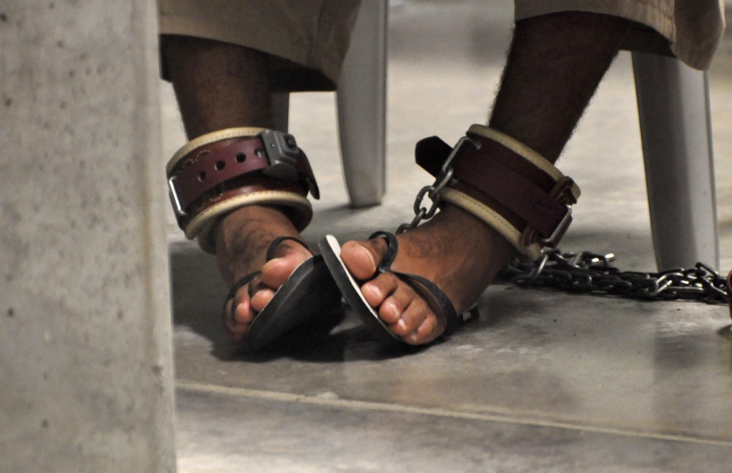 In this photo, reviewed by a Defense Department official, a Guantanamo detainee’s feet are shackled to the floor as he attends a “Life Skills” class inside the Camp 6 high-security detention facility at Guantanamo Bay Naval Base, April 27, 2010. Credit: Reuters/Michelle Shephard/Pool