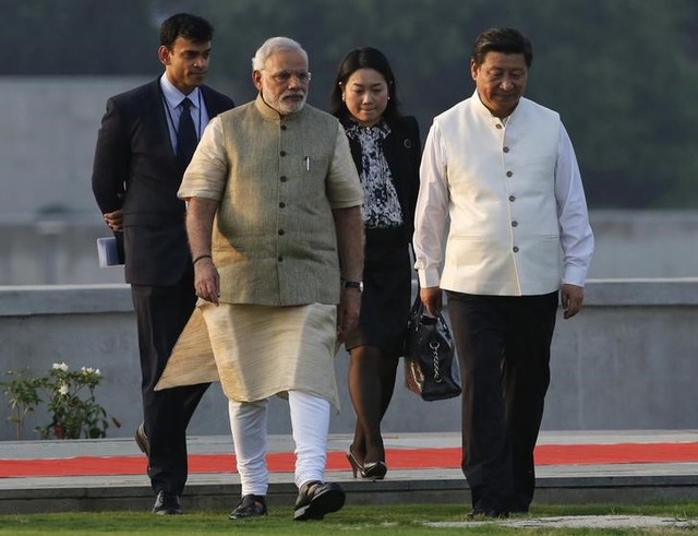 China's President Xi Jinping (R) walks with Prime Minister Narendra Modi (2nd L) during his visit to the Sabarmati river front in Ahmedabad, September 17, 2014. Credit: Reuters/Amit Dave/Files