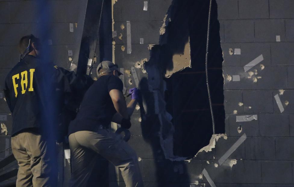 Police forensic investigators work at the crime scene of a mass shooting at the Pulse gay night club in Orlando, Florida. Credit: Reuters/Jim Young