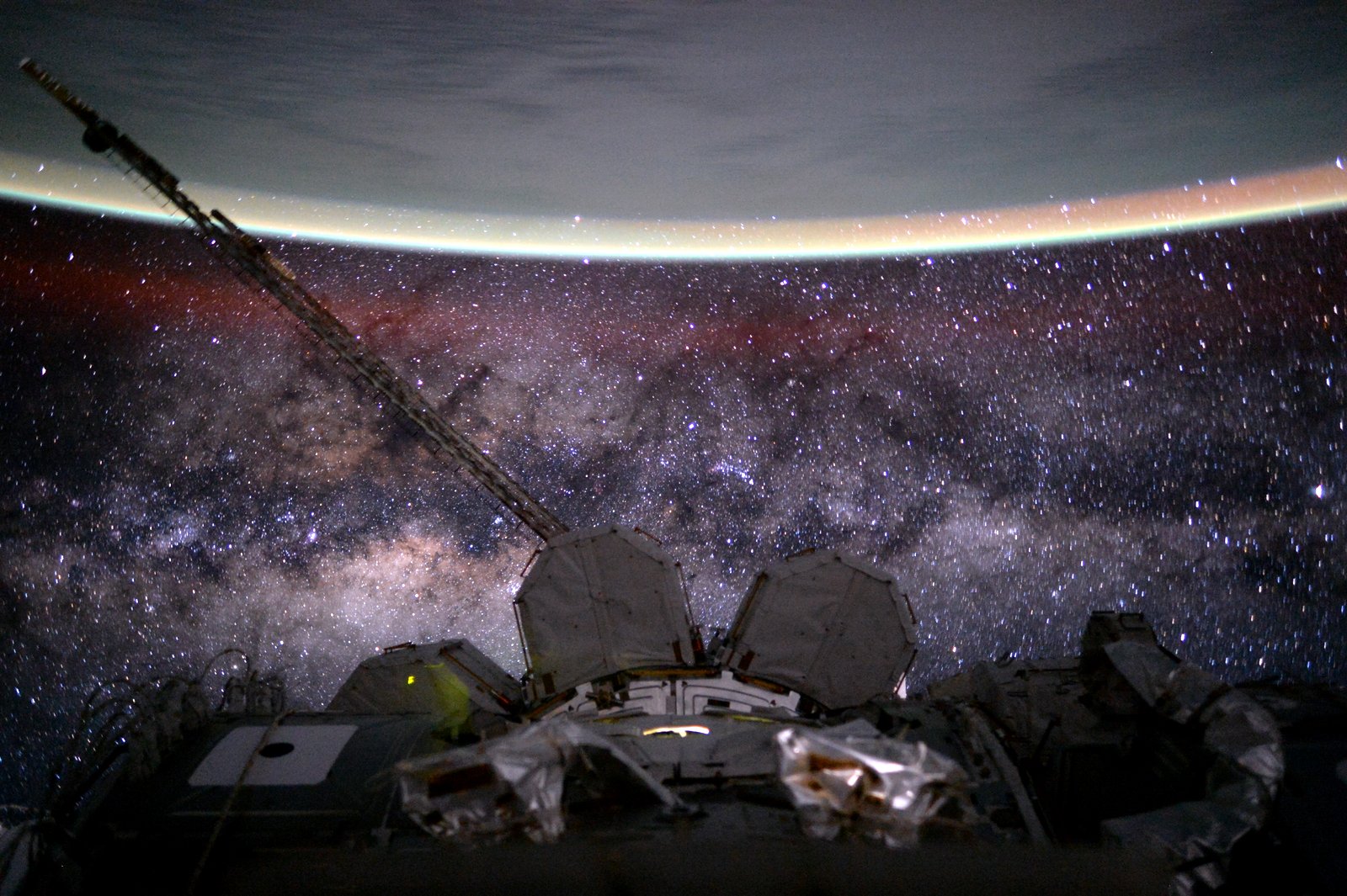 The central band of the Milky Way as seen from the ISS. Earth is visible on top. Credit: Scott Kelly/NASA