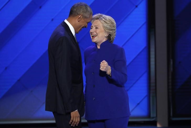 U.S. President Barack Obama and Democratic presidential nominee Hillary Clinton appear onstage together after his speech on the third night at the Democratic National Convention in Philadelphia, Pennsylvania, U.S. July 27, 2016. Mike Segar, Reuters/ Files