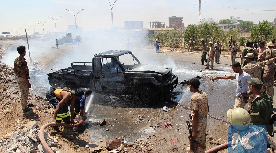 Soldiers extinguish a fire on a pick-up truck at the site of a car bomb attack in a central square in the port city of Aden, Yemen, May 1, 2016, that targeted the city's security chief for the second time in a week. REUTERS/Fawaz Salman