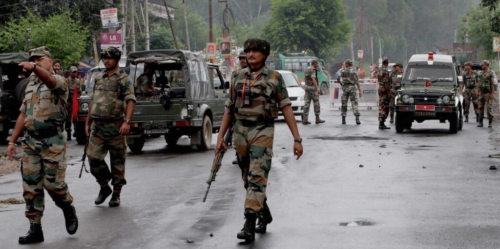 Jammu: Army personnel guard at a street during curfew in Jammu on Monday. The curfew has been clamped by the authorities in the view of violent protests over Kishtwar clash. Credit: PTI