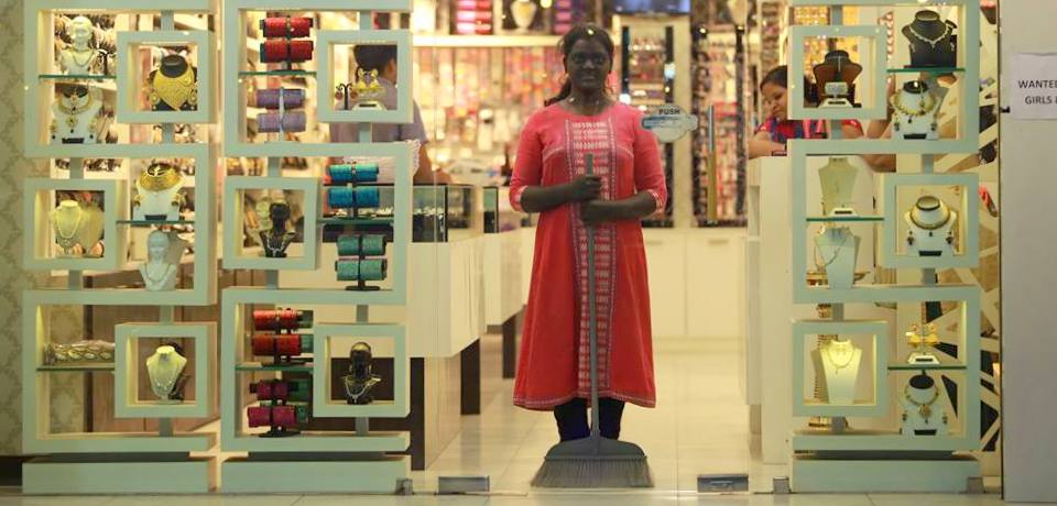 P.S. Jaya posing in a jewellery and cosmetics shop window with a painted face and body. Credit: Facebook