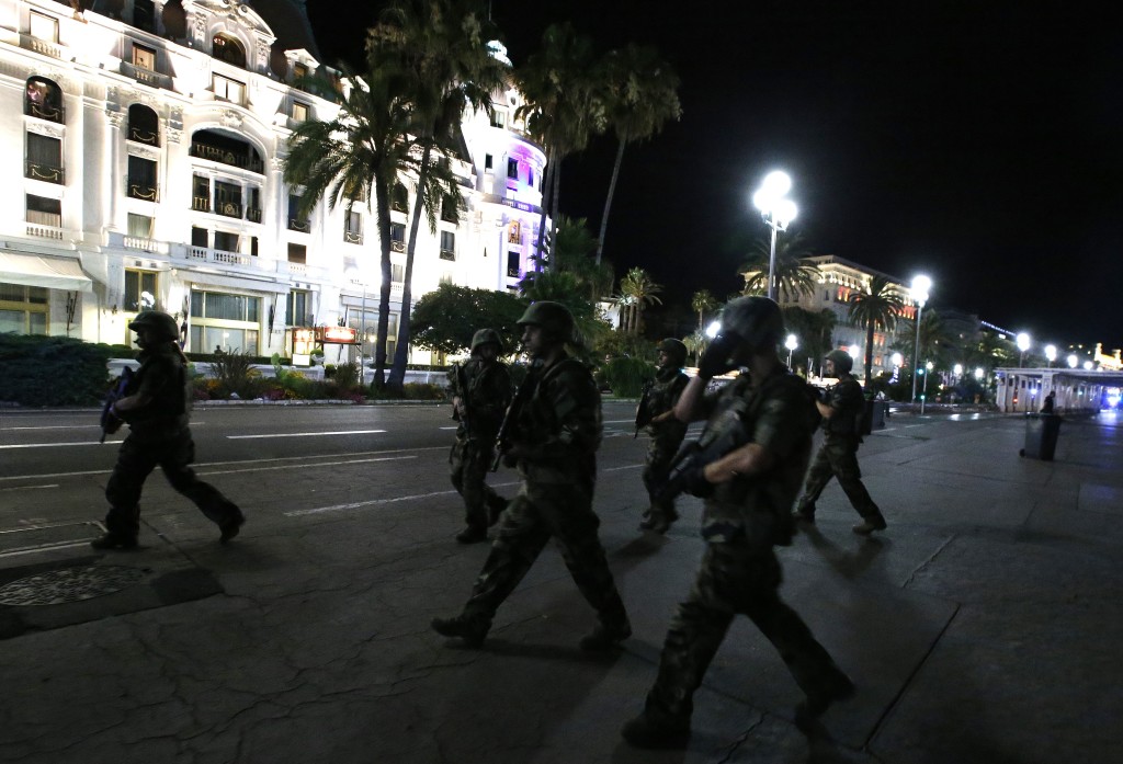 French soldiers advance on the street after a truck ran into a crowd celebrating the Bastille Day national holiday in Nice, France. Credit: REUTERS/Eric Gaillard
