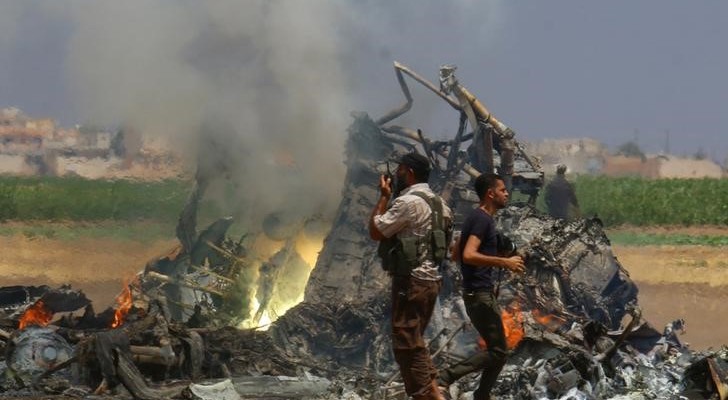 Men inspect the wreckage of a Russian helicopter that had been shot down in the north of Syria's rebel-held Idlib province, Syria August 1, 2016. Credit: Reuters/Ammar Abdullah