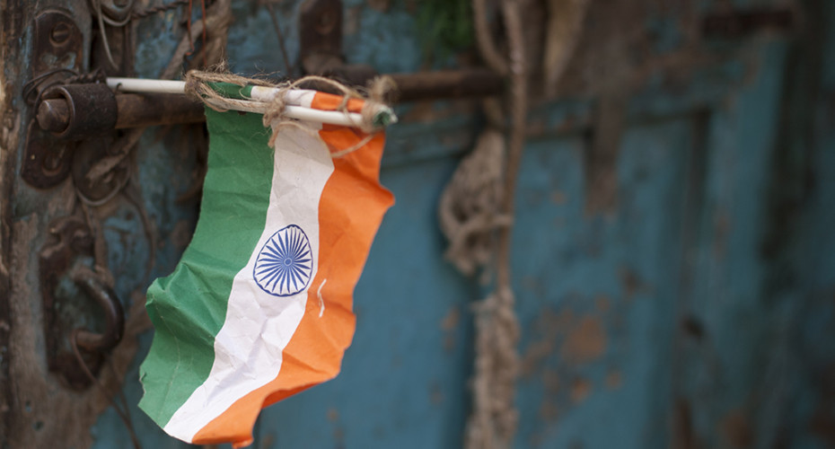 Fragile Freedom: A crumpled paper flag at a doorway in Ahmedabad. Credit: Meena Kadri/Flickr CC BY-NC-ND 2.0