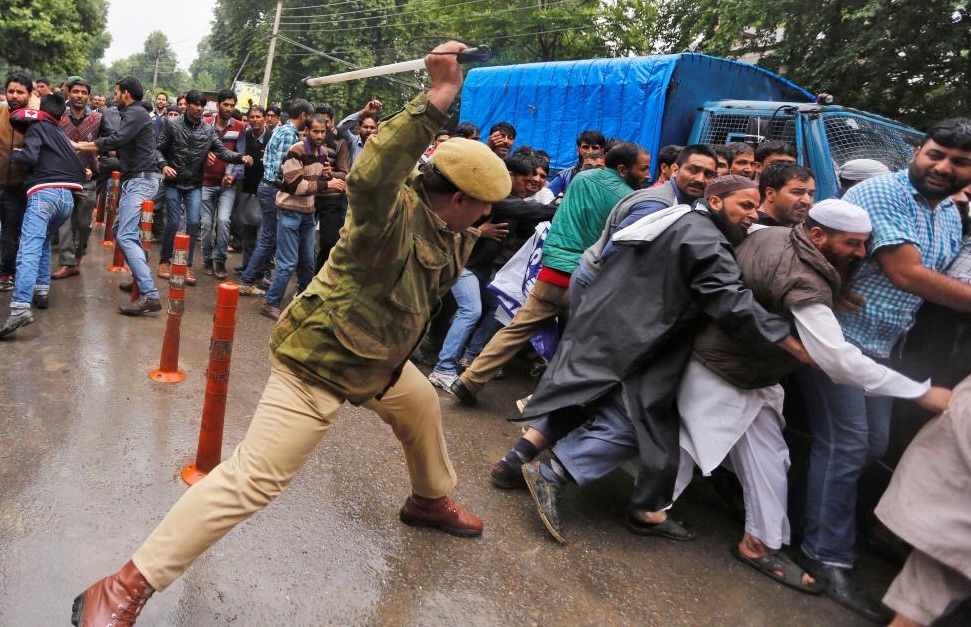 Police clashing with protestors in Srinagar. Credit: Danish Ismail/Reuters