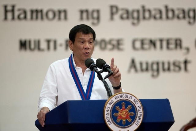 Philippine President Rodrigo Duterte gestures while delivering a speech during the 115th Police Service Anniversary at the Philippine National Police headquarters in Quezon city, metro Manila, Philippines