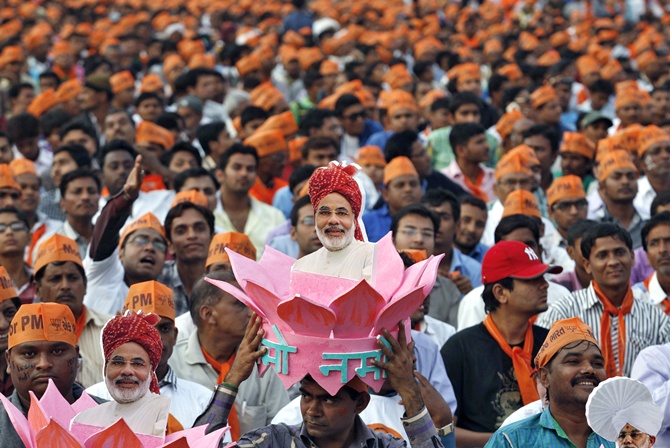 A supporter of Narendra Modi wears a headgear with a portrait of Modi during a rally ahead of the 2014 general elections. Credit: Reuters/Amit Dave/Files