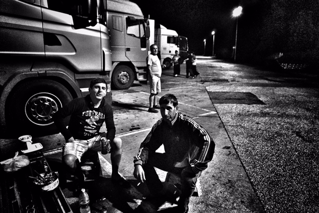 Alexander with his fellow truckers hit a motel for dinner and beer just after crossing the Serbian checkpoint. Credit: Shome Basu