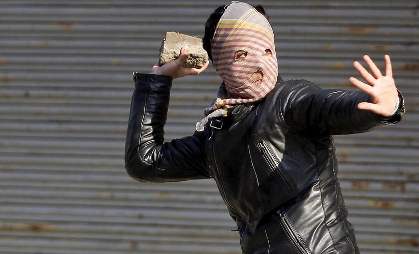 File photo of a A Kashmiri demonstrator throwing a stone towards Indian police (unseen) during a protest in Srinagar . Credit: reuters