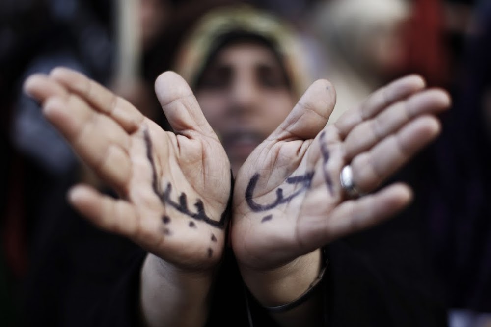 File photo of a woman with the Arabic words for