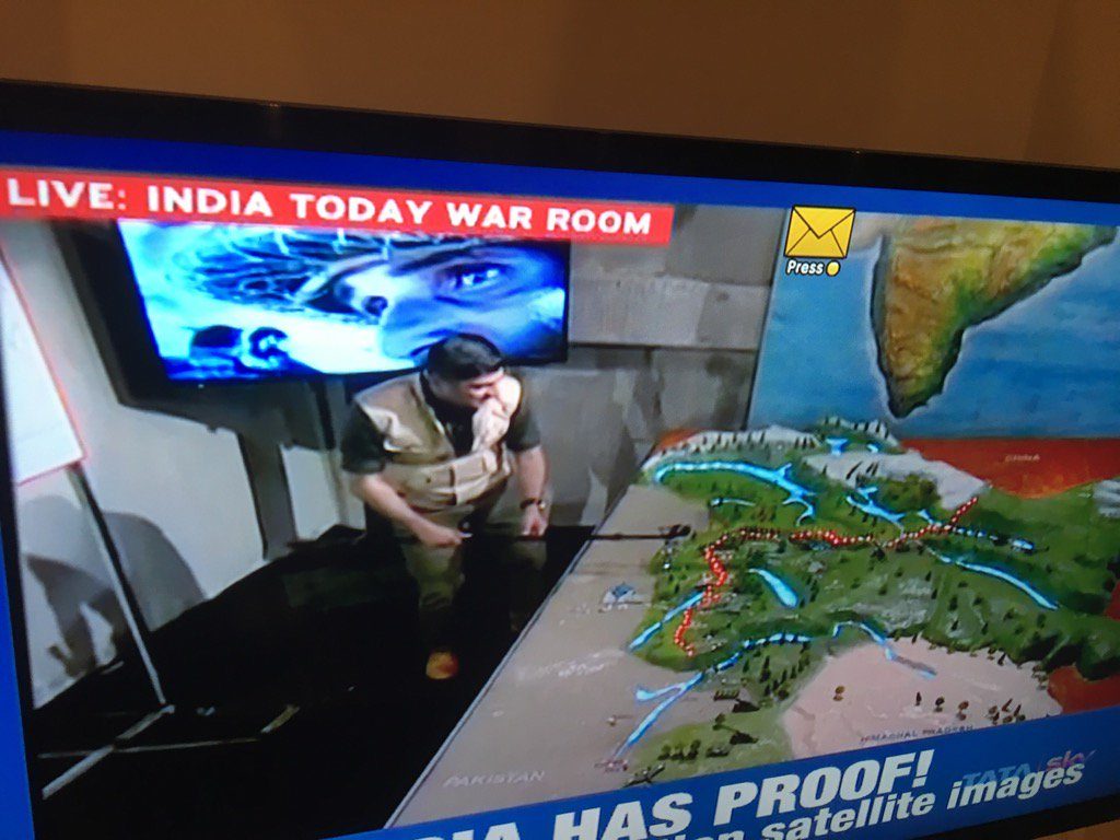 India Today TV anchor in faux military gear at his channel's 'war room'. 