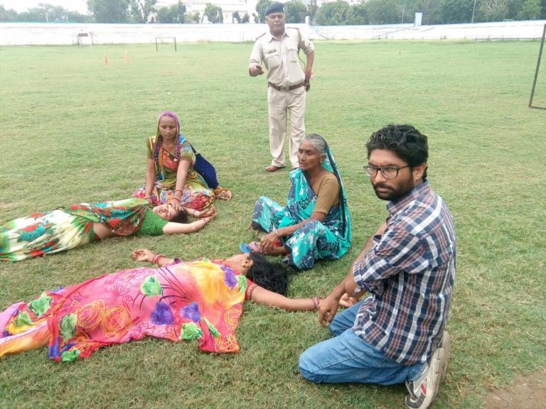 Sept 17 at Shahibaug police HQ, the two women who fell sick await medical treatment. Jignesh Mevani sitting beside them as a cop looks on. Credit: Damayantee Dhar