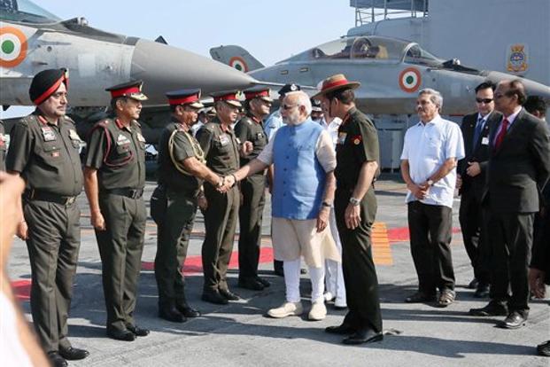 Prime Minister Narendra Modi with defence minister Manohar Parrikar and army chief Dalbir Singh Suhag meeting top army commanders at INS Vikramaditya in Kochi, Kerala. Credit: PTI