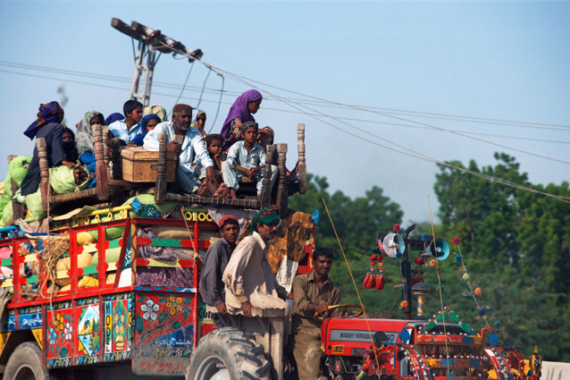 People in Pakistan escaping flooded areas by tractor. Credit: FAO/Hafeez