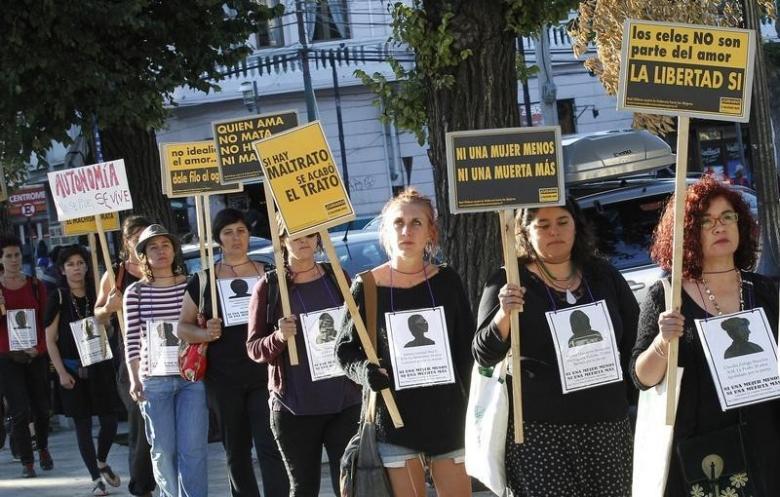 Members of feminist organisations hold signs during a rally against gender violence . Credit: Reuters/Rodrigo Garrido