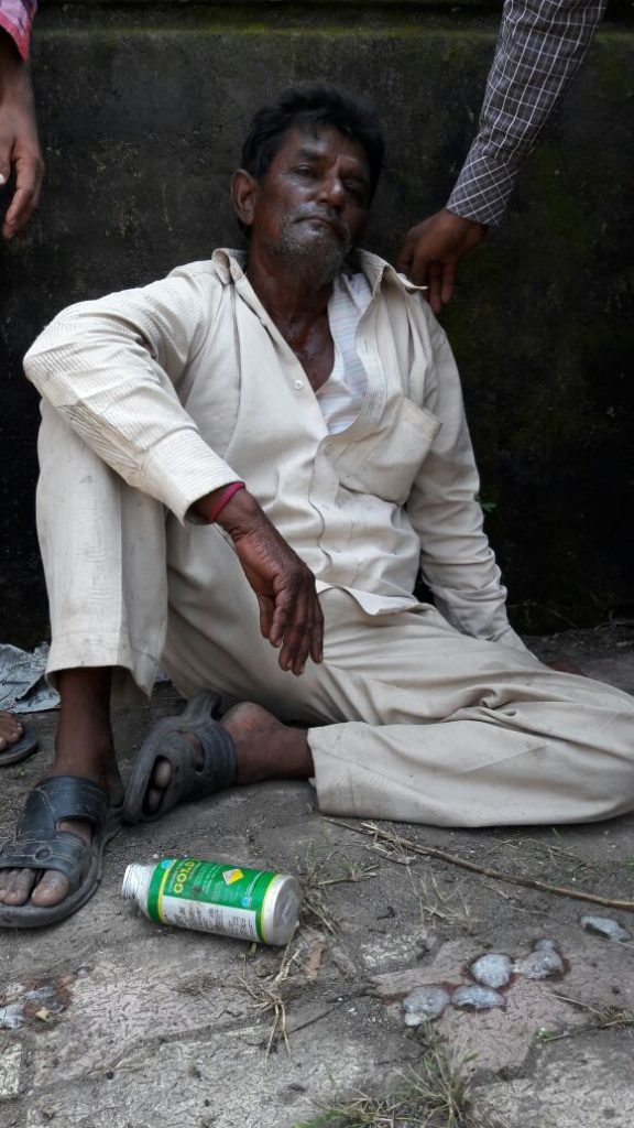Prabhatbhai, still sitting in protest after consuming pesticide while people convince him to get treated. Credit: Damayantee Dhar