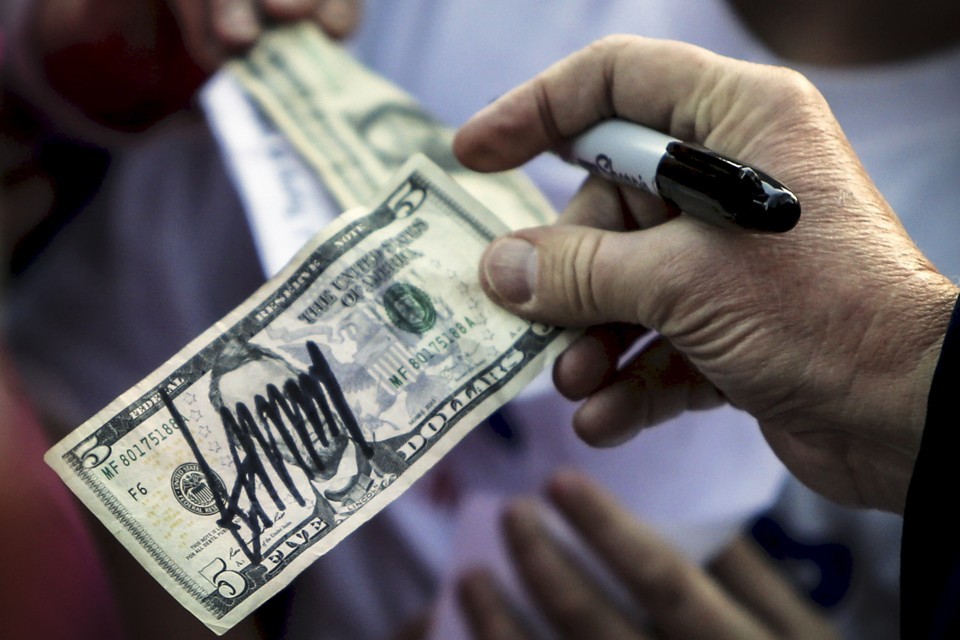 Donald Trump hands an autographed bill to a supporter in South Carolina. Credit: Reuters/Jonathan Ernst/Files