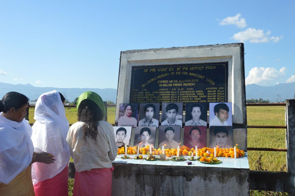 Irom Sharmila, in a green head-scarf, pays tribute at the 16th anniversary memorial of the Malom massacre, which prompted her nearly 16-year hunger strike. Credit: Grace Jajo