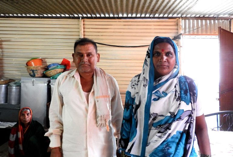 Shalubai with her husband Rajendra Kasbe inside their tin-sheet home; her older sister looks on. Credit: Namita Waikar