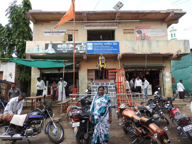 Outside the Wagholi gram panchayat office, Shalubai stands in front of a statue of Chhatrapati Shivaji. Credit: Namita Waikar