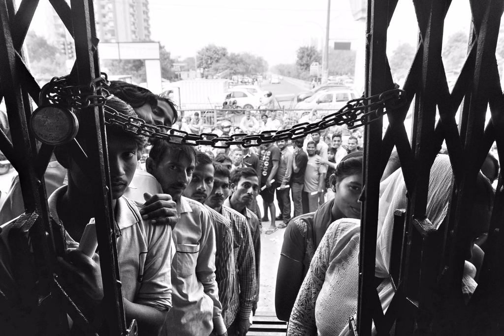 People queue outside a bank. Credit: Shome Basu