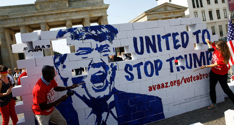 Protestors are tearing down a so called 'Trump's wall of hate' as part of a demonstration against Republican presidential candidate Donald Trump in front of the Brandenburg Gate at the Pariser Platz in Berlin, Germany, Friday, Sept. 23, 2016. Credit: Reuters