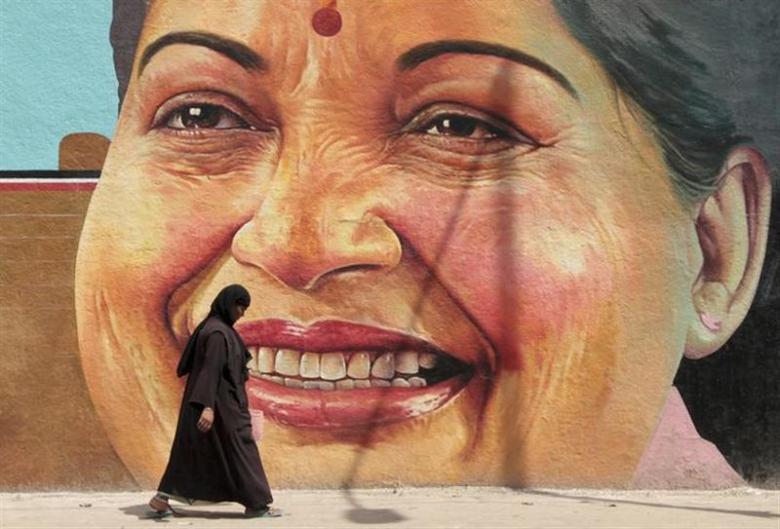 A woman walks past a portrait of J. Jayalalithaa, chief minister of Tamil Nadu, in Chennai March 13, 2012. Credit: Reuters/Babu/Files