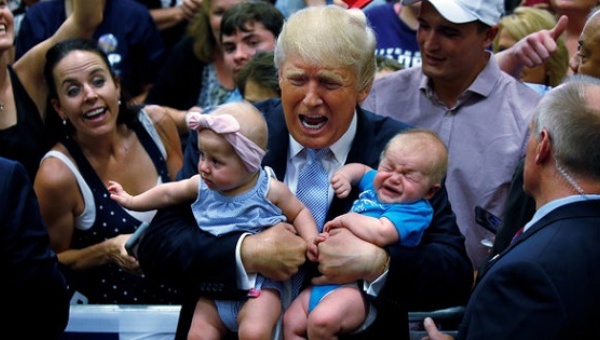 Donald Trump holds babies at a rally in Colorado Springs, Colorado on July 29, 2016. He is not believed to have booted either from that rally. Credit: Reuters