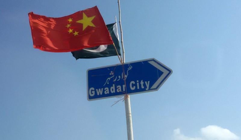 The Chinese and Pakistani flags fly on a sign along a road towards Gwadar, Pakistan January 26, 2016. Credit: Reuters/Syed Raza Hassan