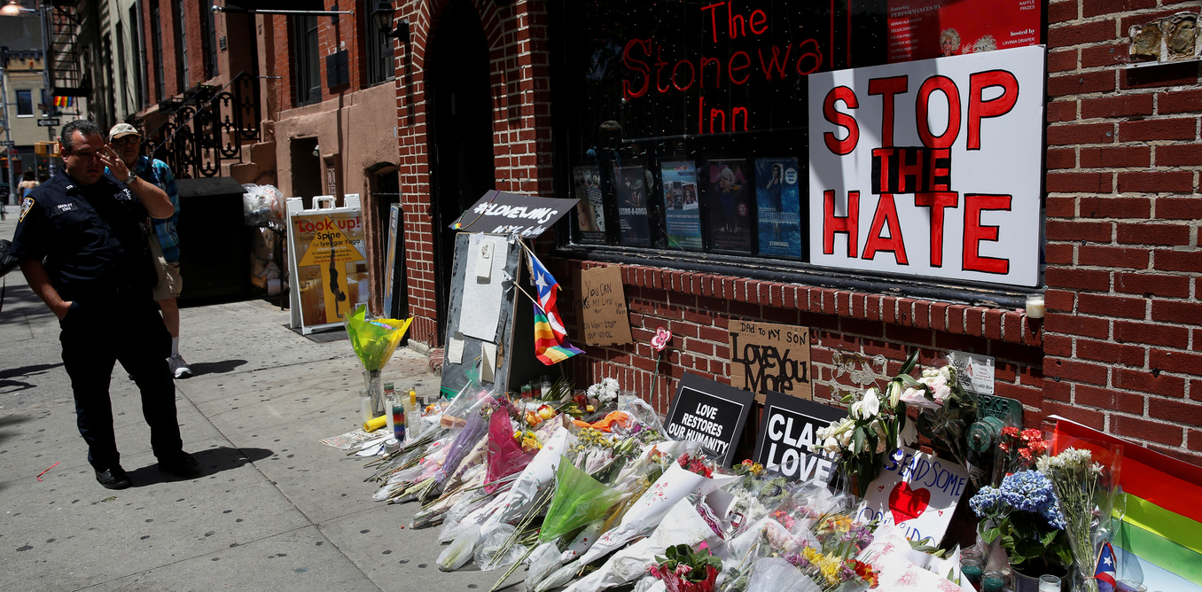 A NYPD officer wipes his eye at a memorial outside The Stonewall Inn remembering the victims of the Orlando massacre in New York, US, June 13, 2016. Credit: Reuters/Shannon Stapleton