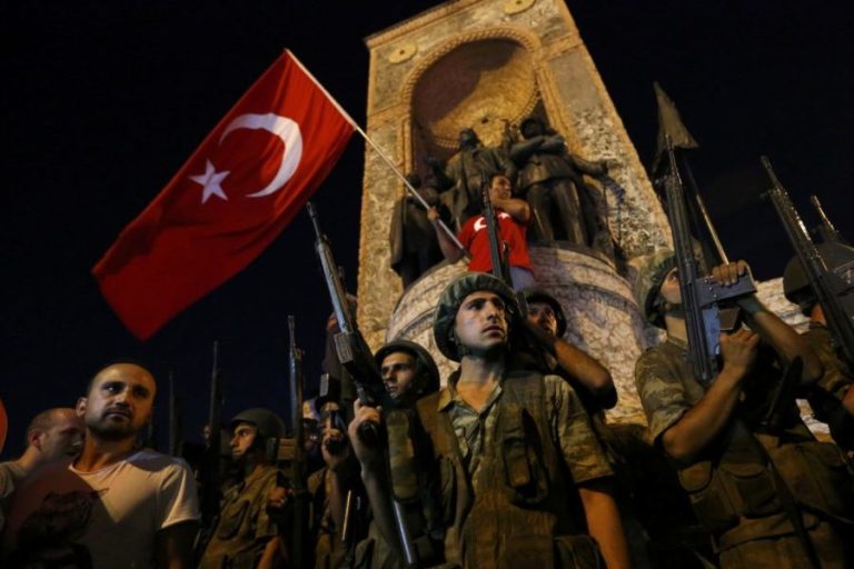Turkish military stand guard near the the Taksim Square as people wave with Turkish flags in Istanbul, Turkey, July 16, 2016. Murad Sezer/Reuters/Files