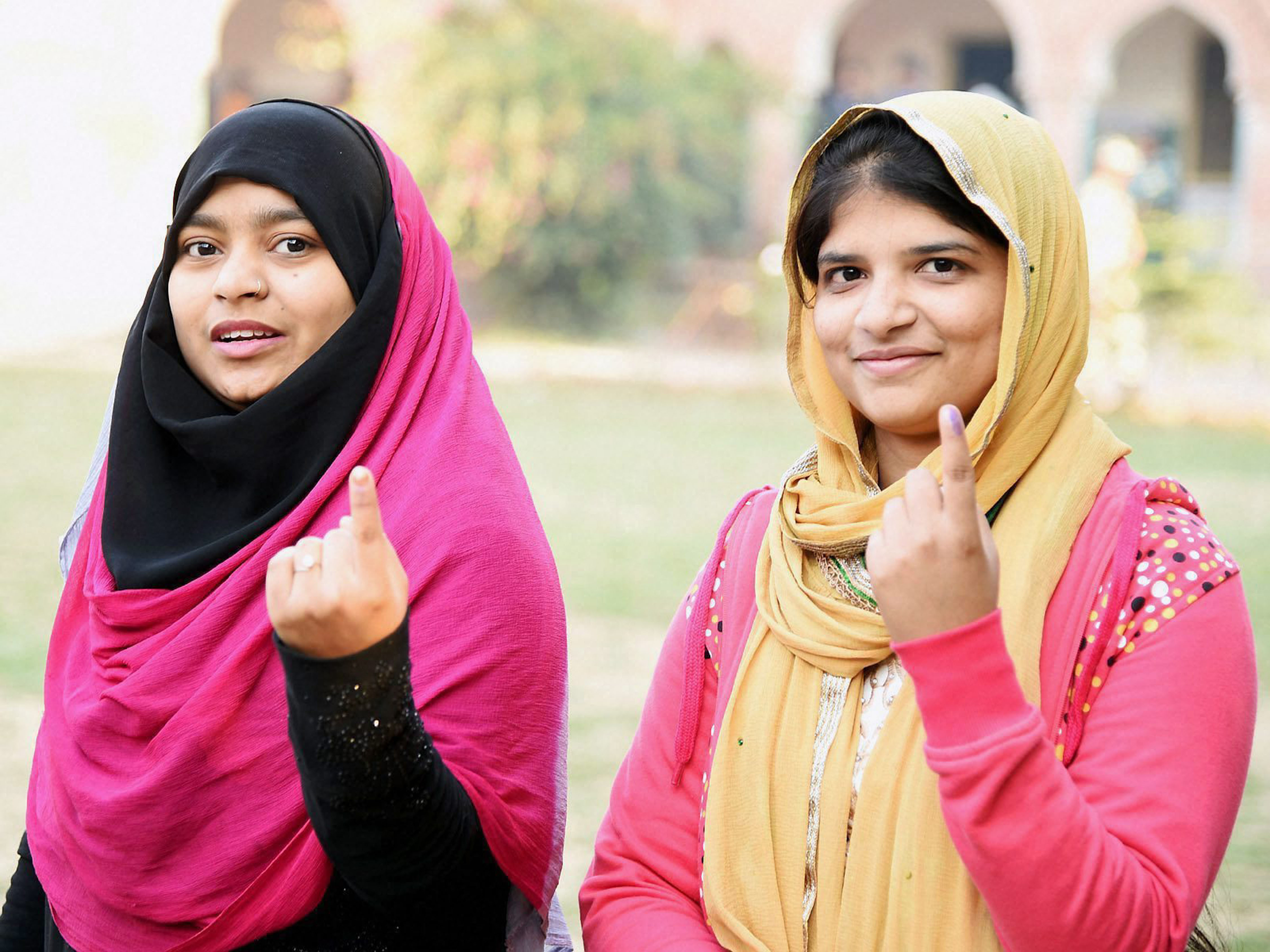 Aligarh: Muslim girls show their inked fingers after casting votes during the first phase of UP Assembly polls in Aligarh on Saturday. PTI Photo (PTI2_11_2017_000210B)