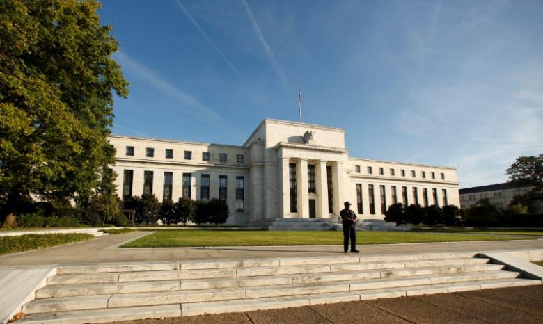 A police officer keeps watch in front of the US Federal Reserve building in Washington, DC, US on October 12, 2016. Credit: Reuters/Kevin Lamarque/File Photo