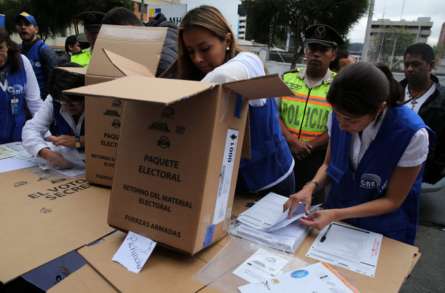 Workers of the Electoral National Council prepare electoral materials during a program for people with disabilities to vote in advance in the Sunday's presidential election, in Quito, Ecuador, February 17, 2017. Credit: Reuters