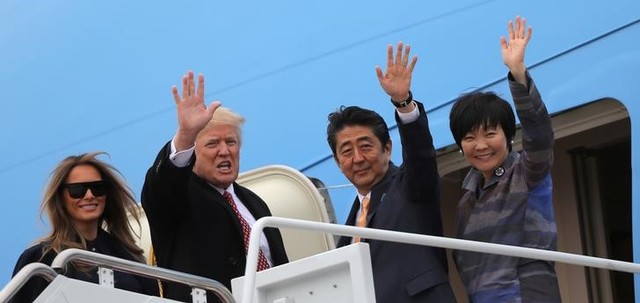 US President Donald Trump and his wife Melania (L) wave with Japanese Prime Minister Shinzo Abe (2nd R) and his wife Akie Abe while boarding Air Force One as they depart for Palm Beach, Florida, at Joint Base Andrews, Maryland, US, February 10, 2017. Credit: Reuters