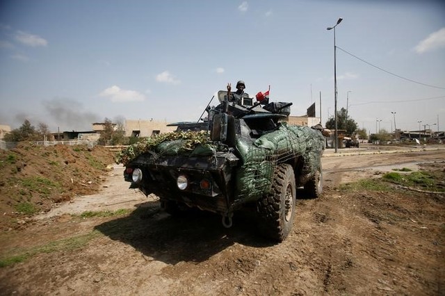 A member of federal police sits in an armoured vehicle during a battle with ISIS militants in Mosul, Iraq March 29, 2017. Credit: Reuters