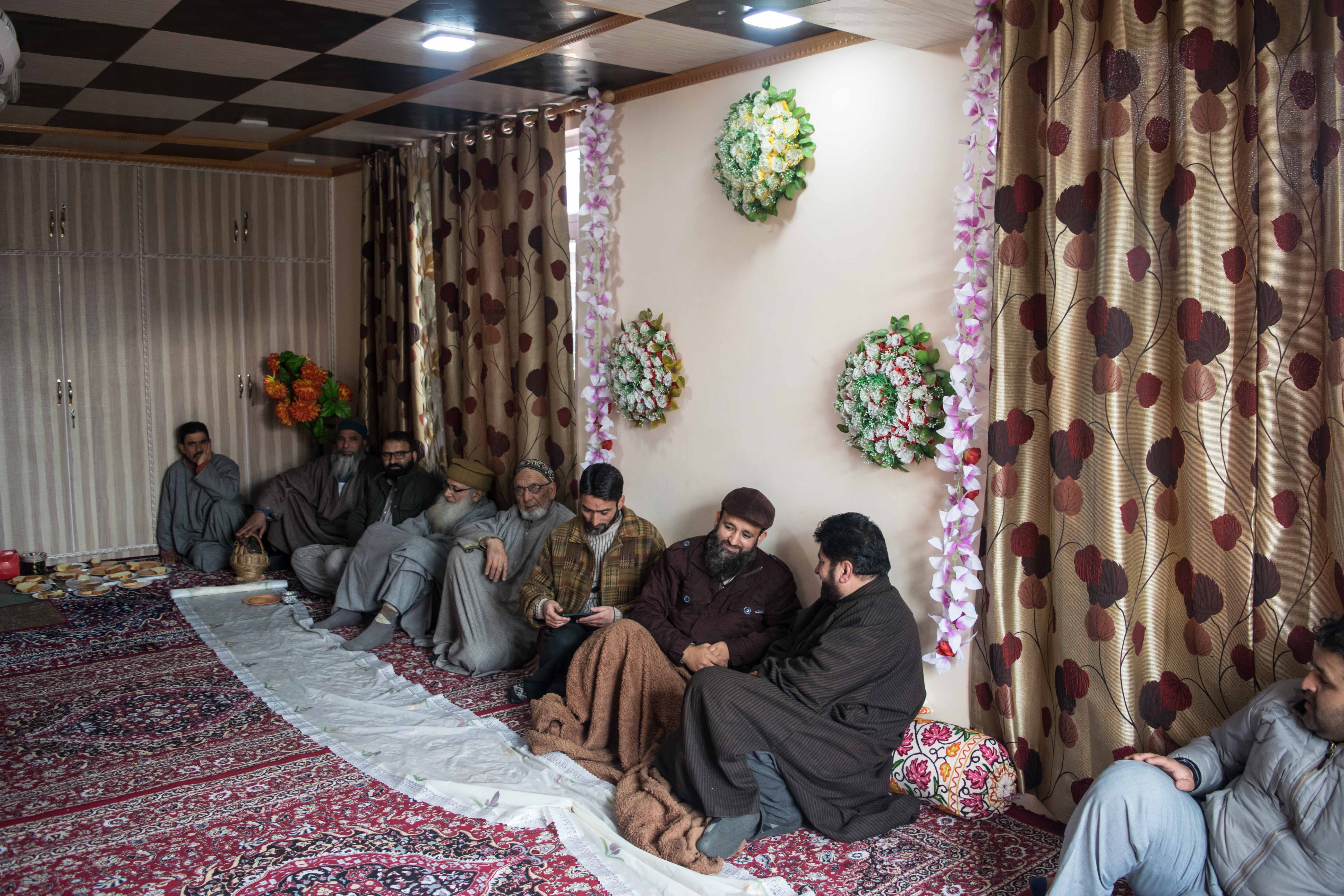 Tariq Ahmed Dar seen with visitors and family. Credit: Ruman Hamdani