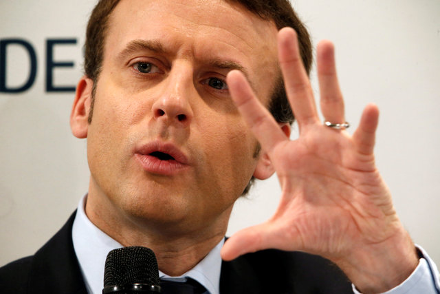 Emmanuel Macron, head of the political movement En Marche !, or Onwards !, and candidate for the 2017 French presidential election, gestures as he delivers a speech in front of small business leaders in Puteaux, France, March 6, 2017. Credit: Reuters