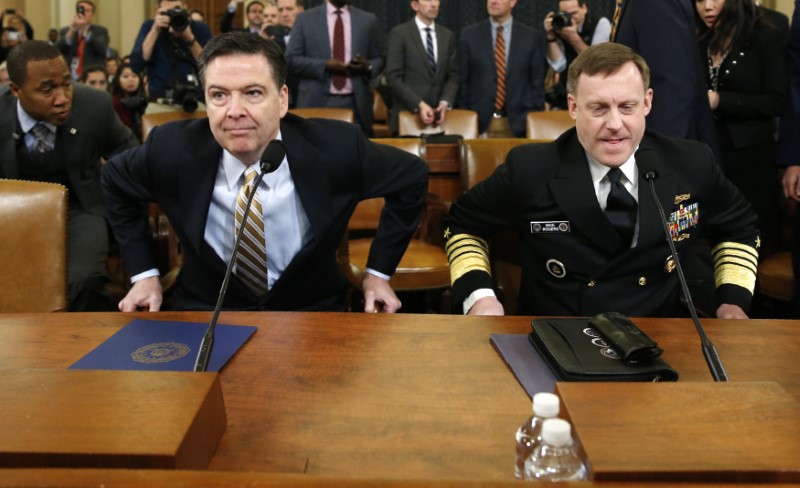 FBI director James Comey (L) and National Security Agency Director Mike Rogers take their seats at a House Intelligence Committee hearing into alleged Russian meddling in the 2016 US election, on Capitol Hill in Washington, US, March 20, 2017. Credit: Reuters/Joshua Roberts